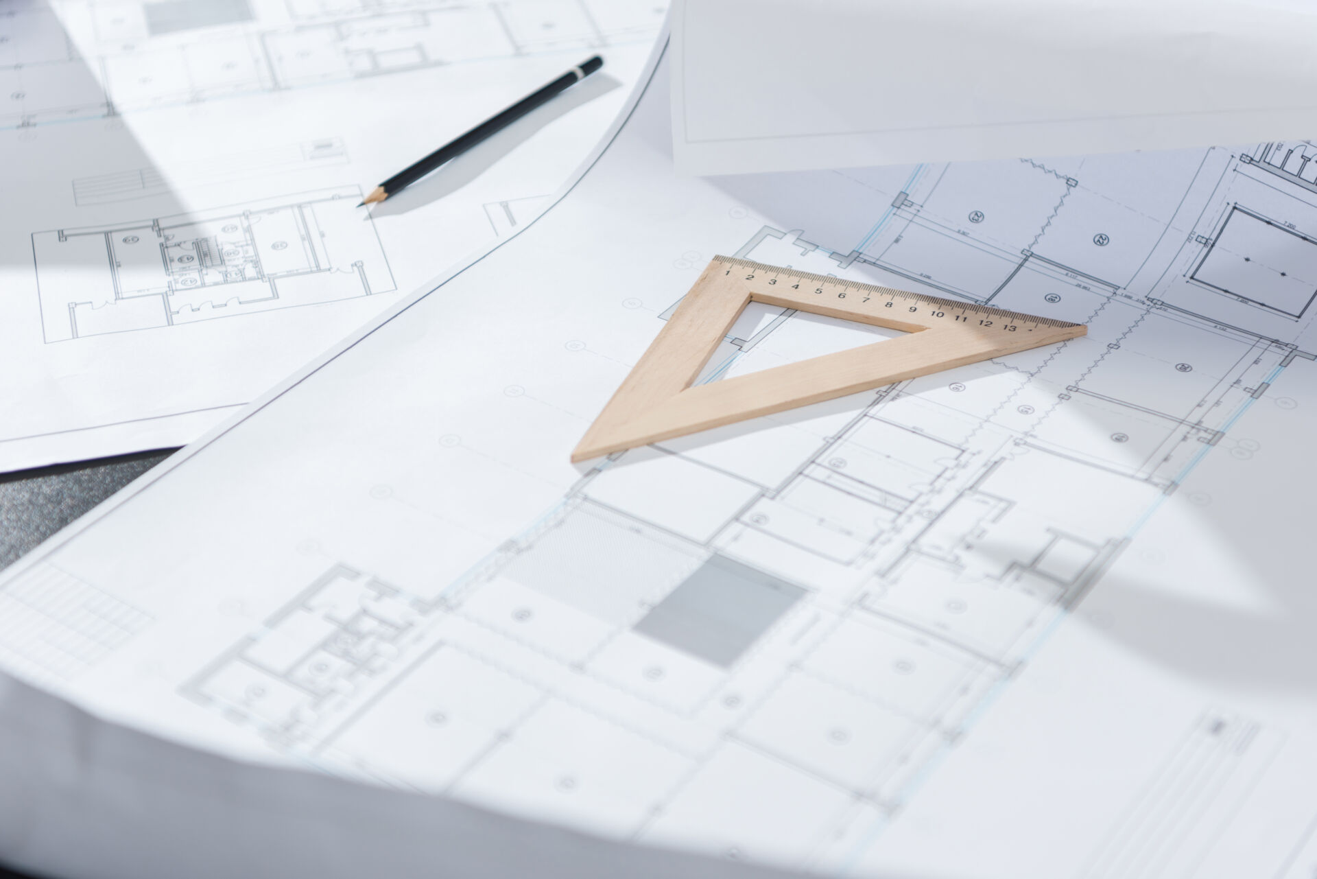 Close-up shot of architecture plans and drawing supplies on table for borehole drilling