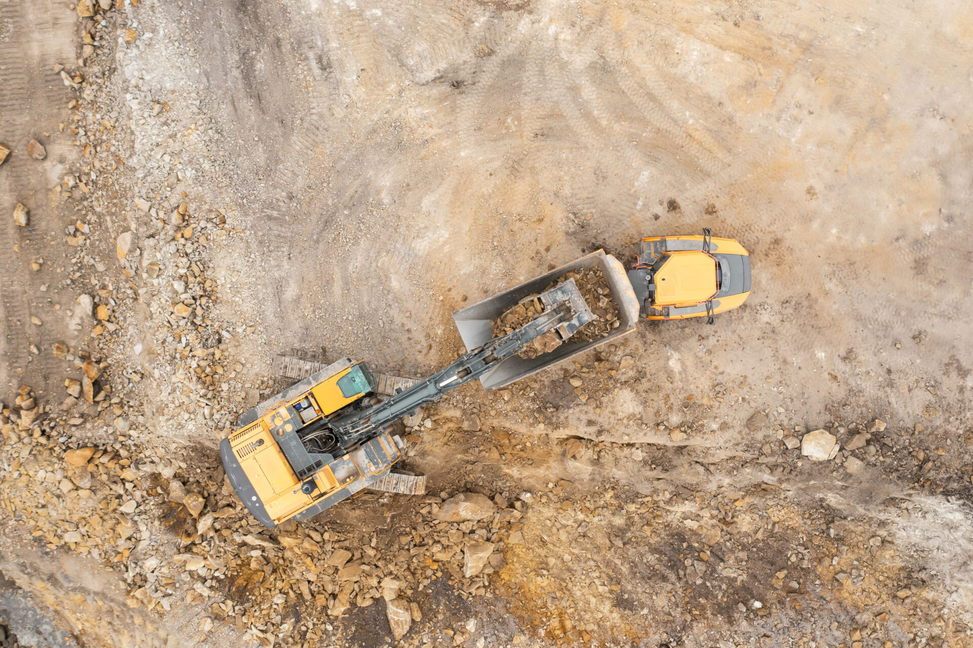 Heavy industrial excavator digs the ground and transfers it to the truck for ground investigation in London, Surrey, Sussex and South East England