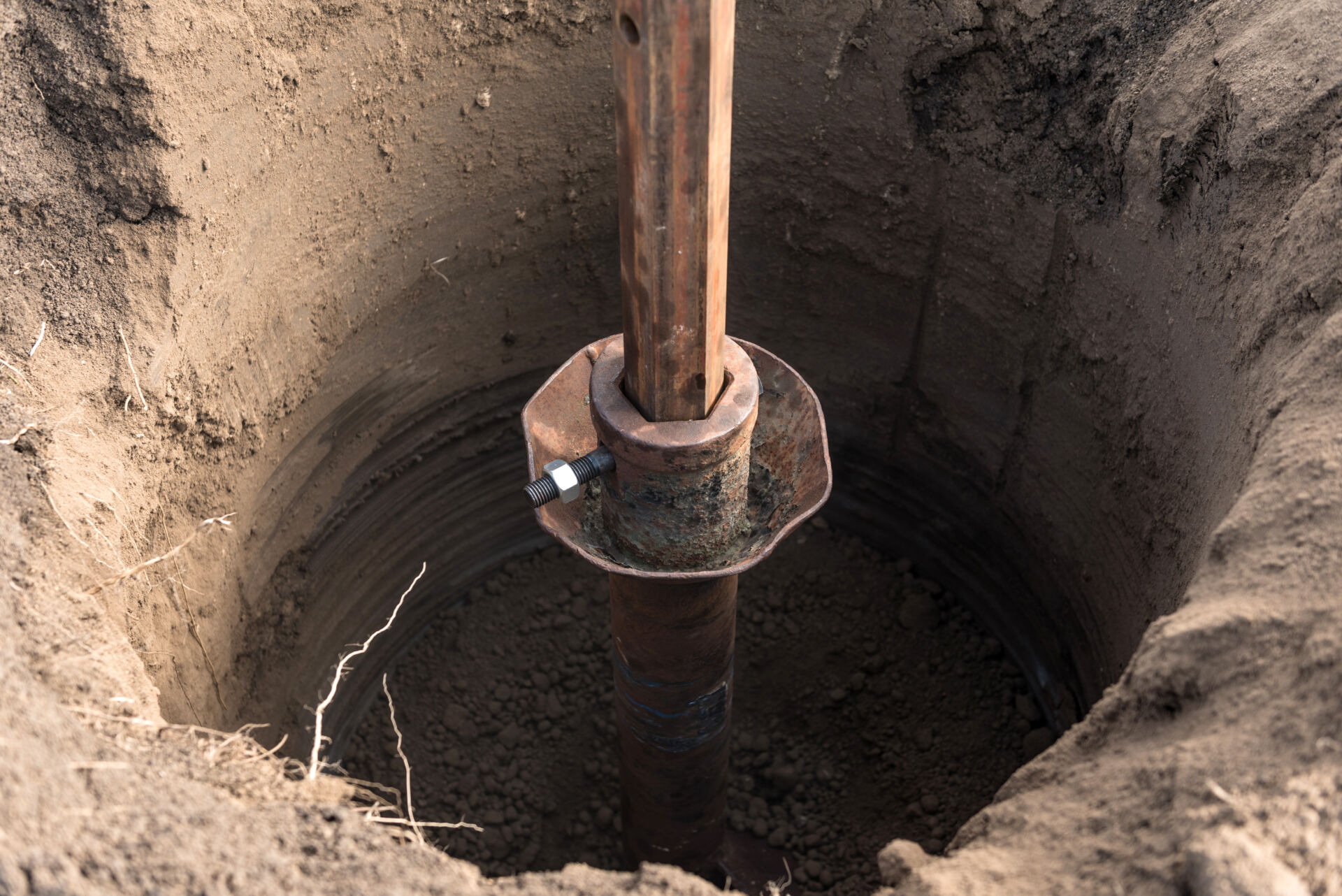 Tracer tractor with auger for soil borehole drilling for piles installation during construction of buildings and structures